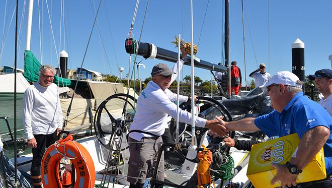 Stephen Proud skipper of Swish receiving his pineapple & XXXX 2014 B2K race © Keppel Bay Marina